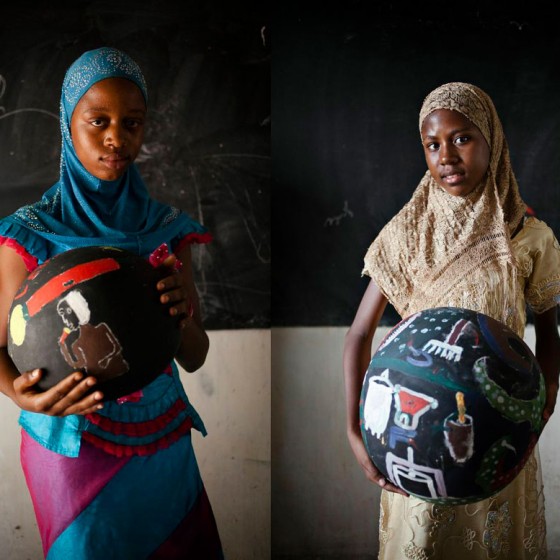 girls from Senegal holding painted bowls