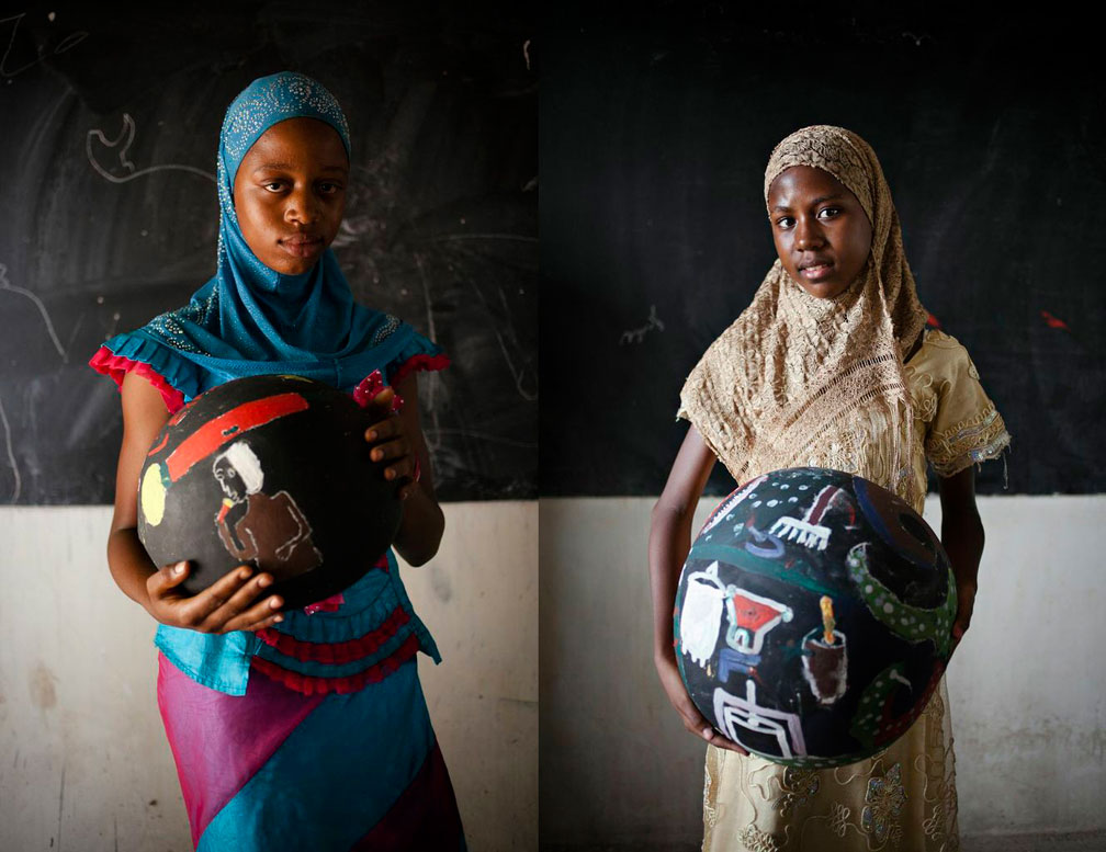 girls from Senegal holding painted bowls