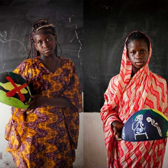 girls from Senegal holding painted bowls