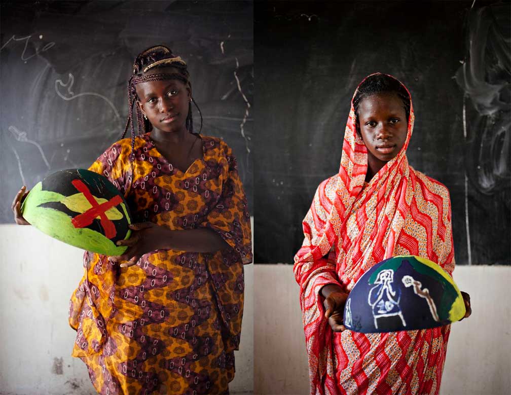 girls from Senegal holding painted bowls