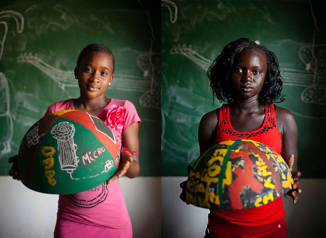 girls from Senegal holding painted bowls