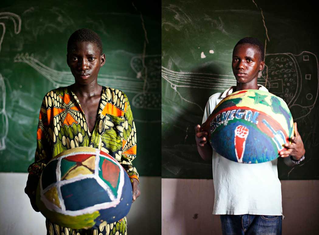 boys from Senegal holding painted bowls