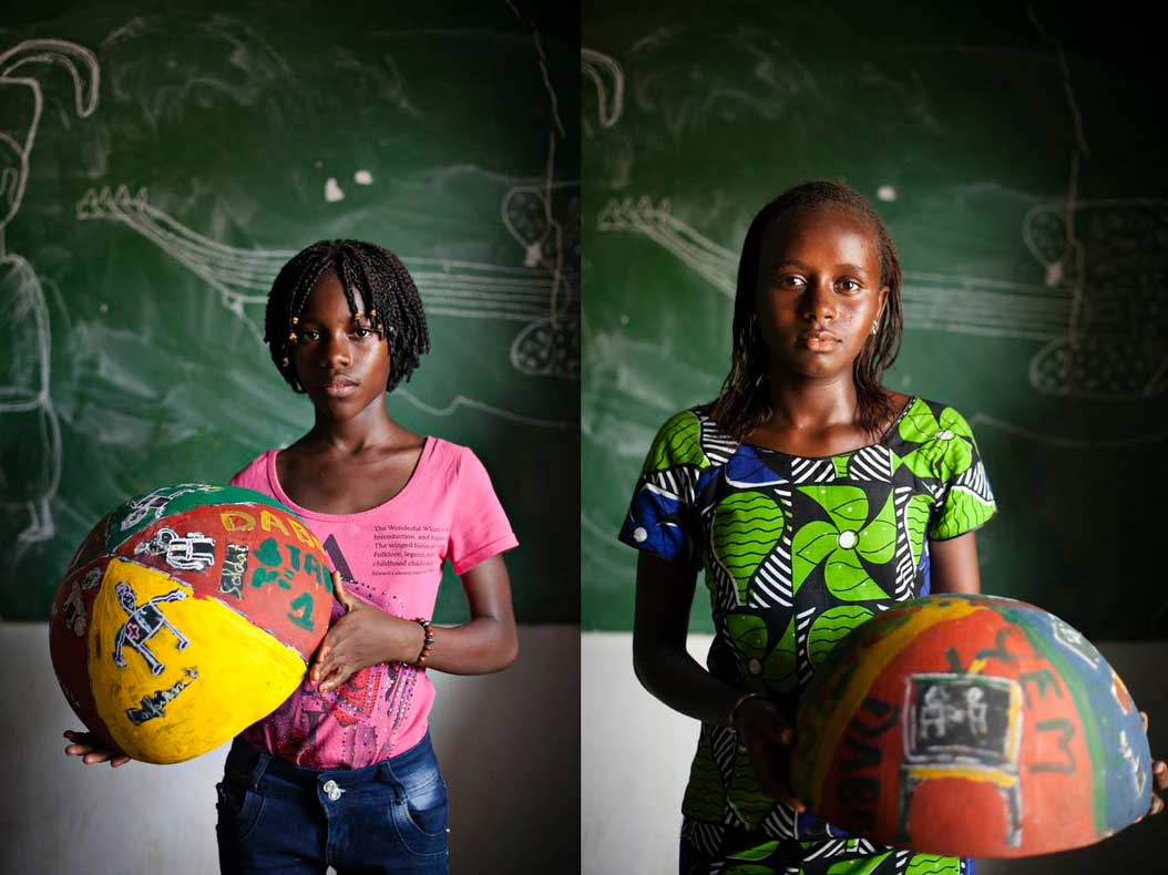 girls from Senegal holding painted bowls