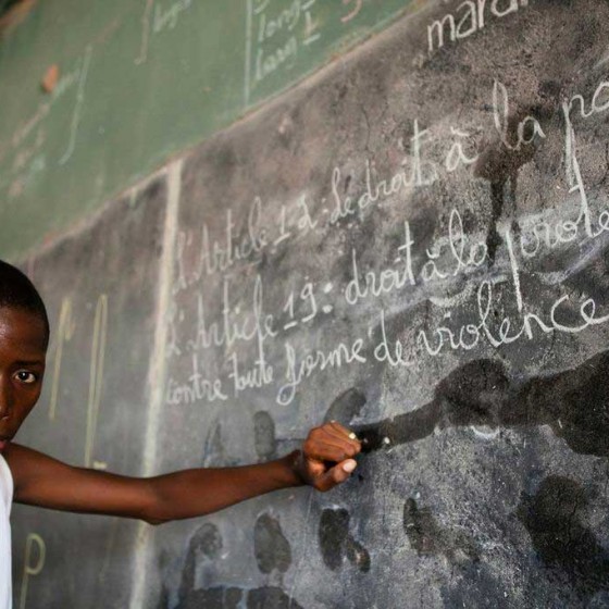 child from Senegal at blackboard