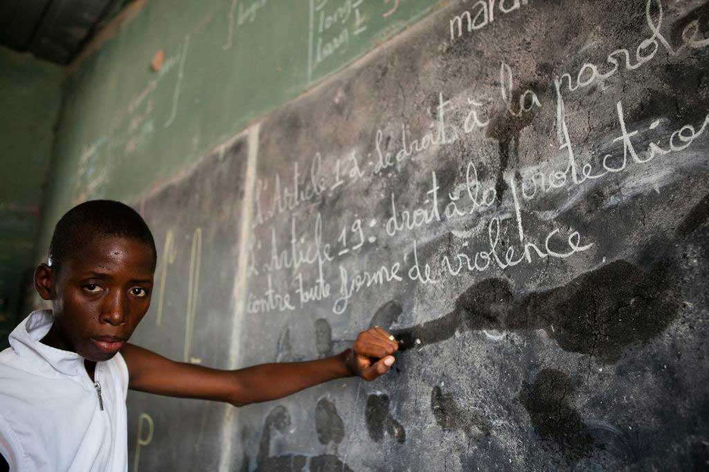 child from Senegal at blackboard