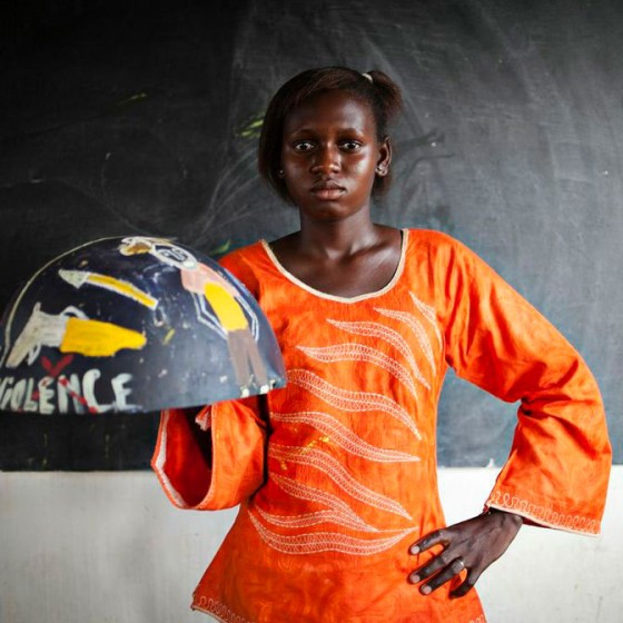 girl from Senegal holding painted bowl