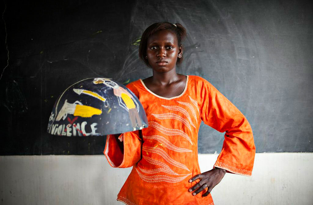 girl from Senegal holding painted bowl