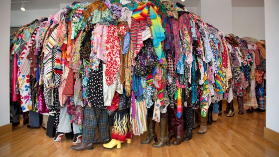 sculpture in form of line of people covered in discarded textiles
