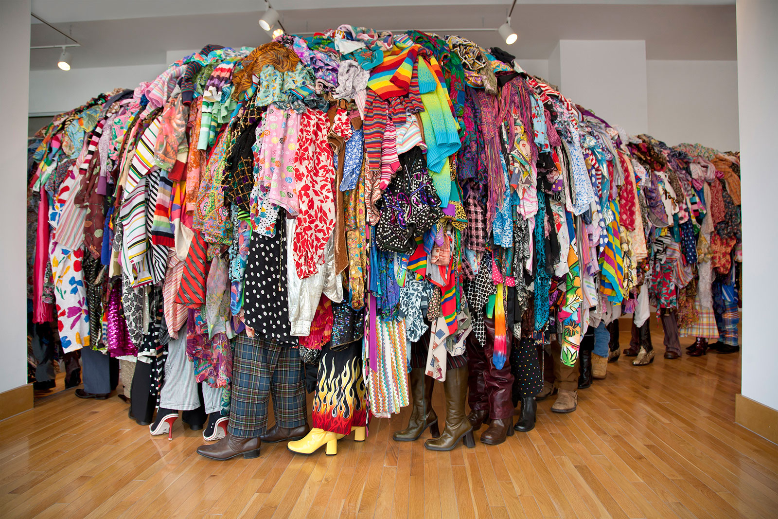 sculpture in form of line of people covered in discarded textiles