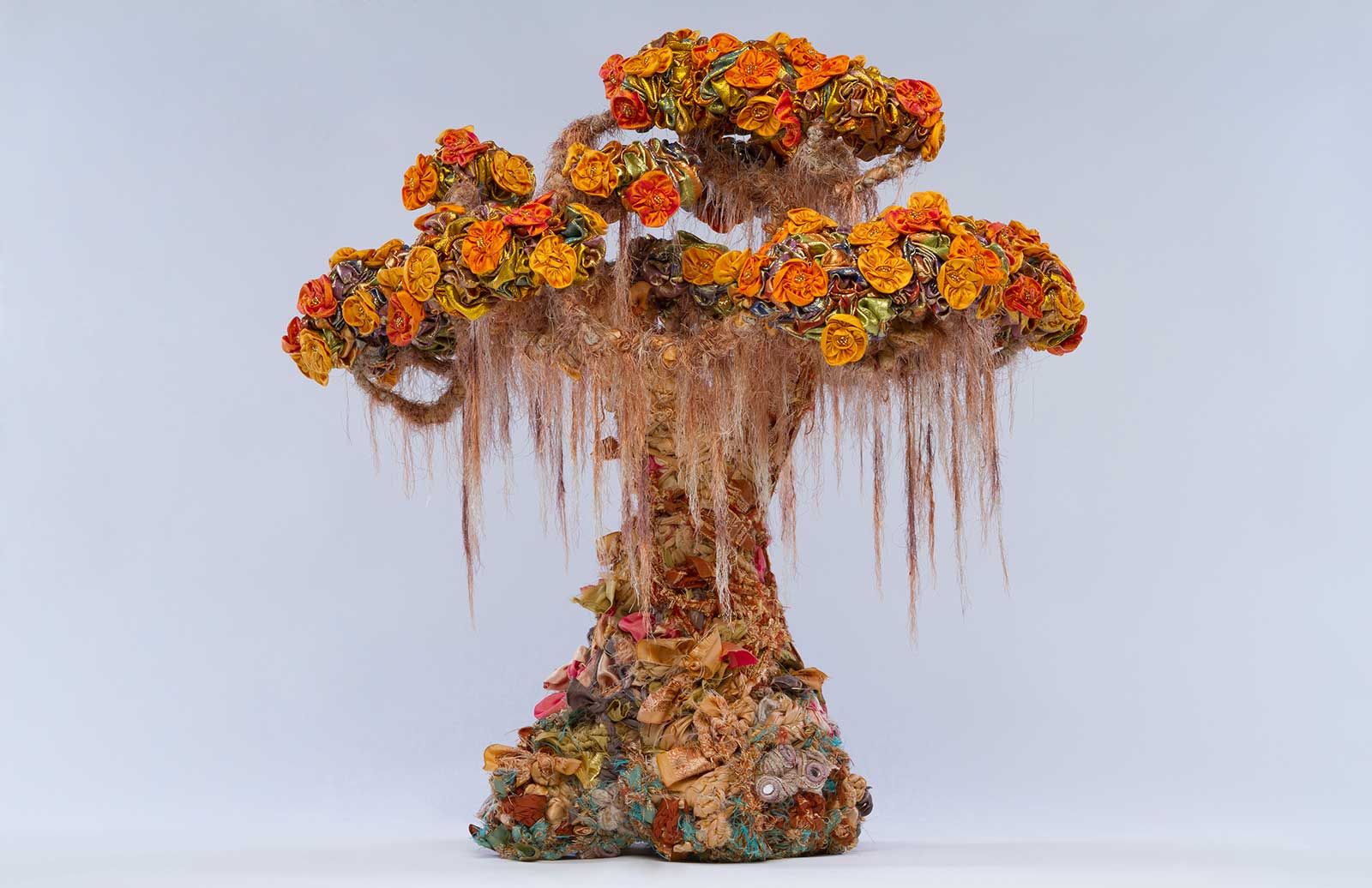 sculpture in form of bonsai tree made from discarded textiles