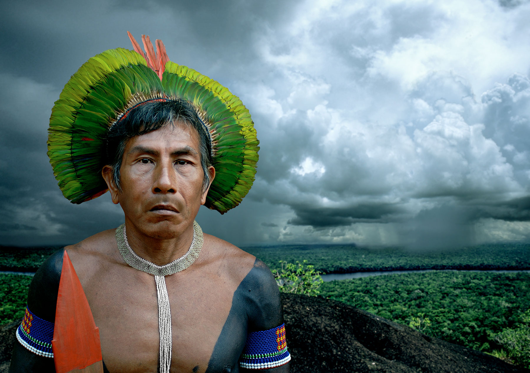indigenous man in front of natural landscape