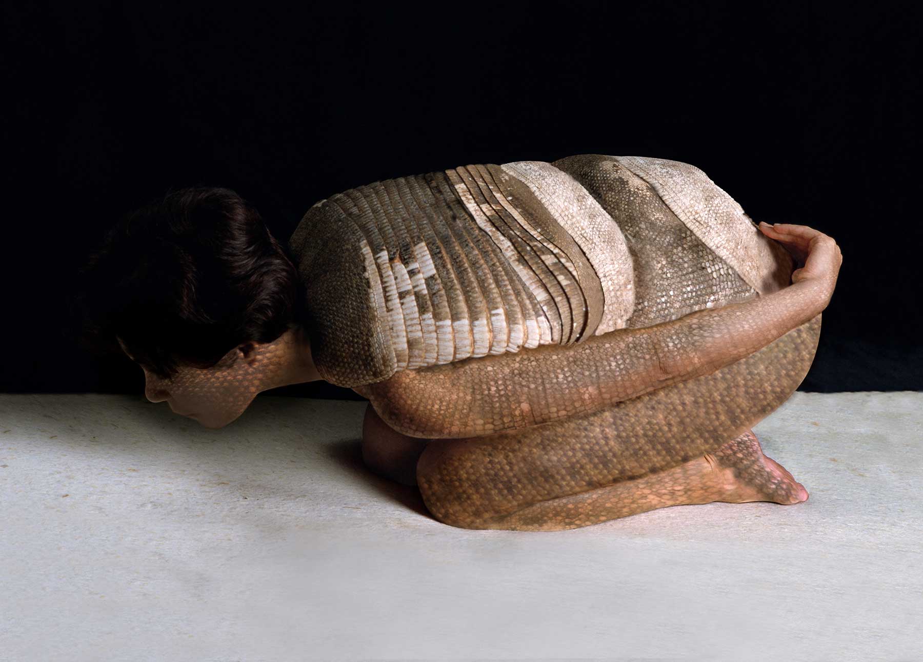 woman with body painted appearance of an armadillo