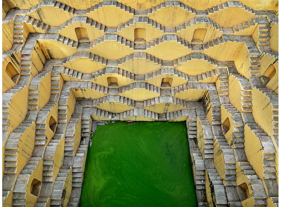 concrete stepwell structure with green pool