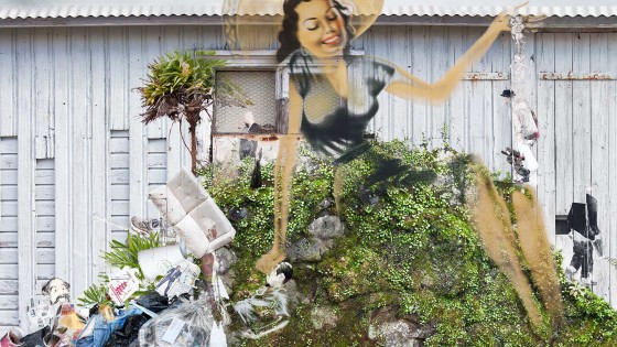 woman on hill with trash