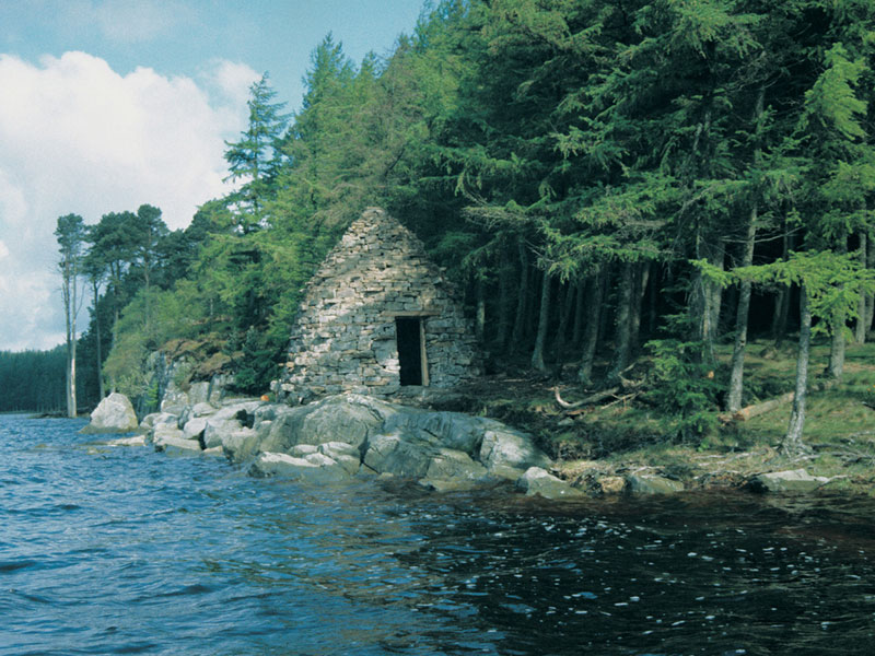 stone hut at edge of water