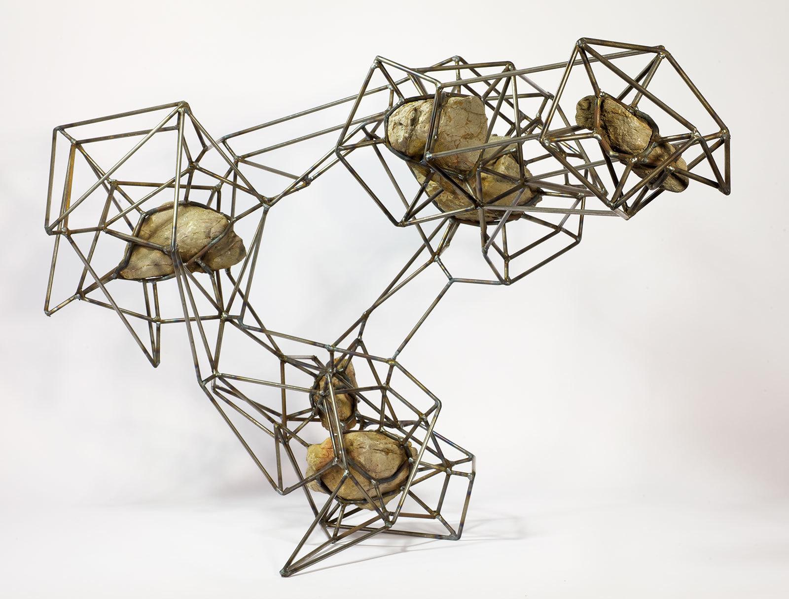 rocks suspended in steel lattice