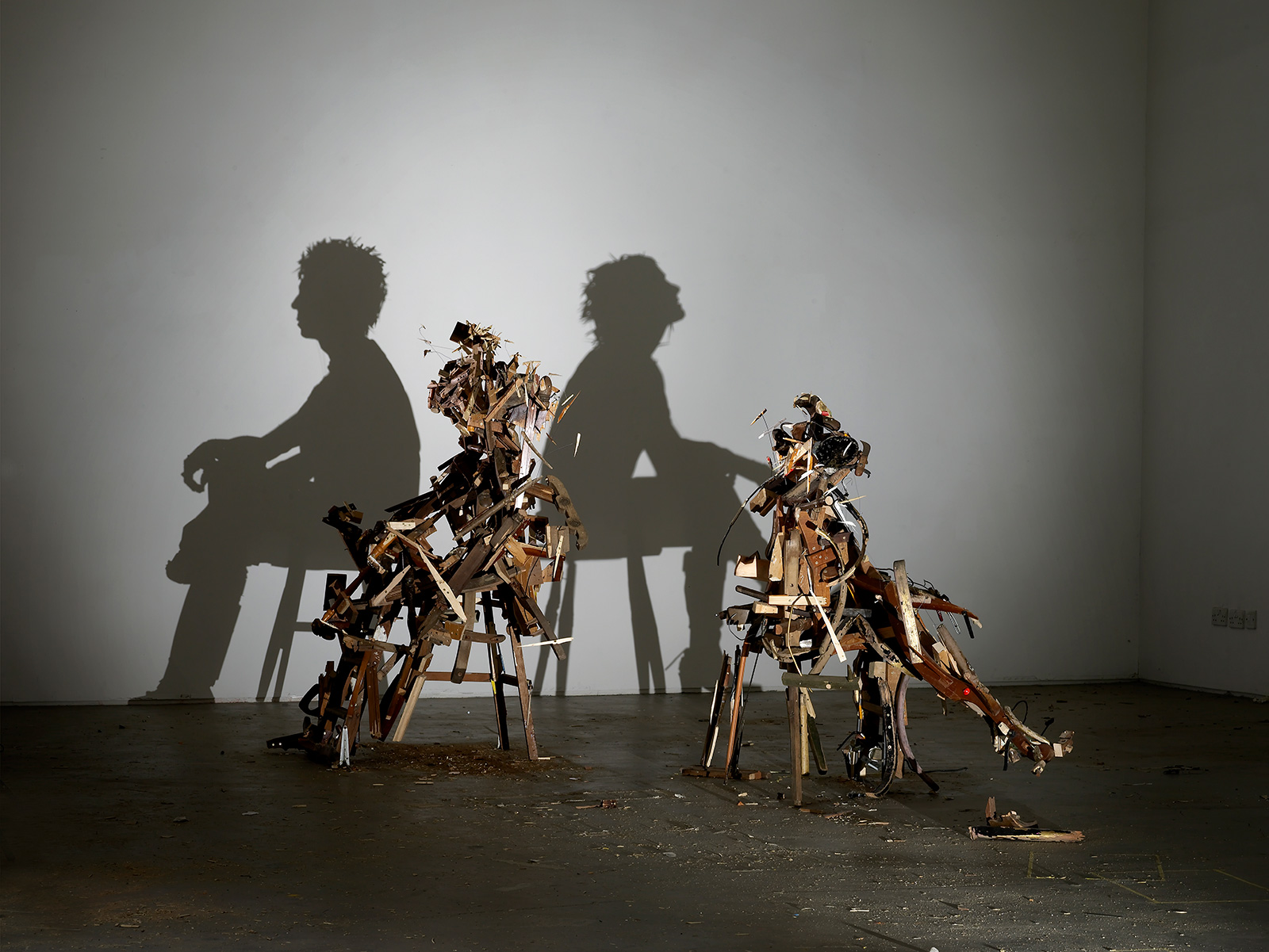 figurative shadow art from wood debris