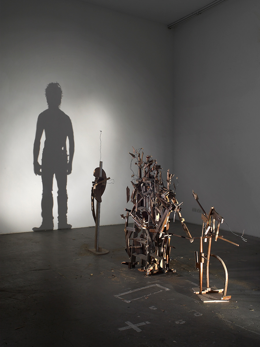 figurative shadow art from wood debris