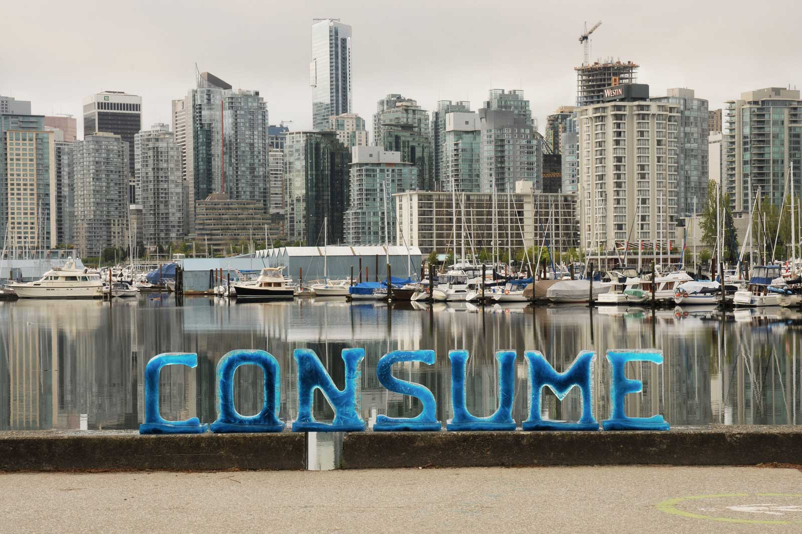 CONSUME spelled with ice letters with city in background