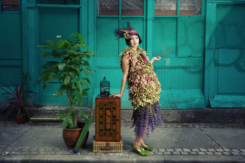 woman in flapper dress made from leaves and other plant materials