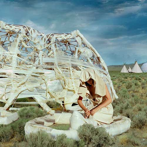 woman in landscape with portable architecture