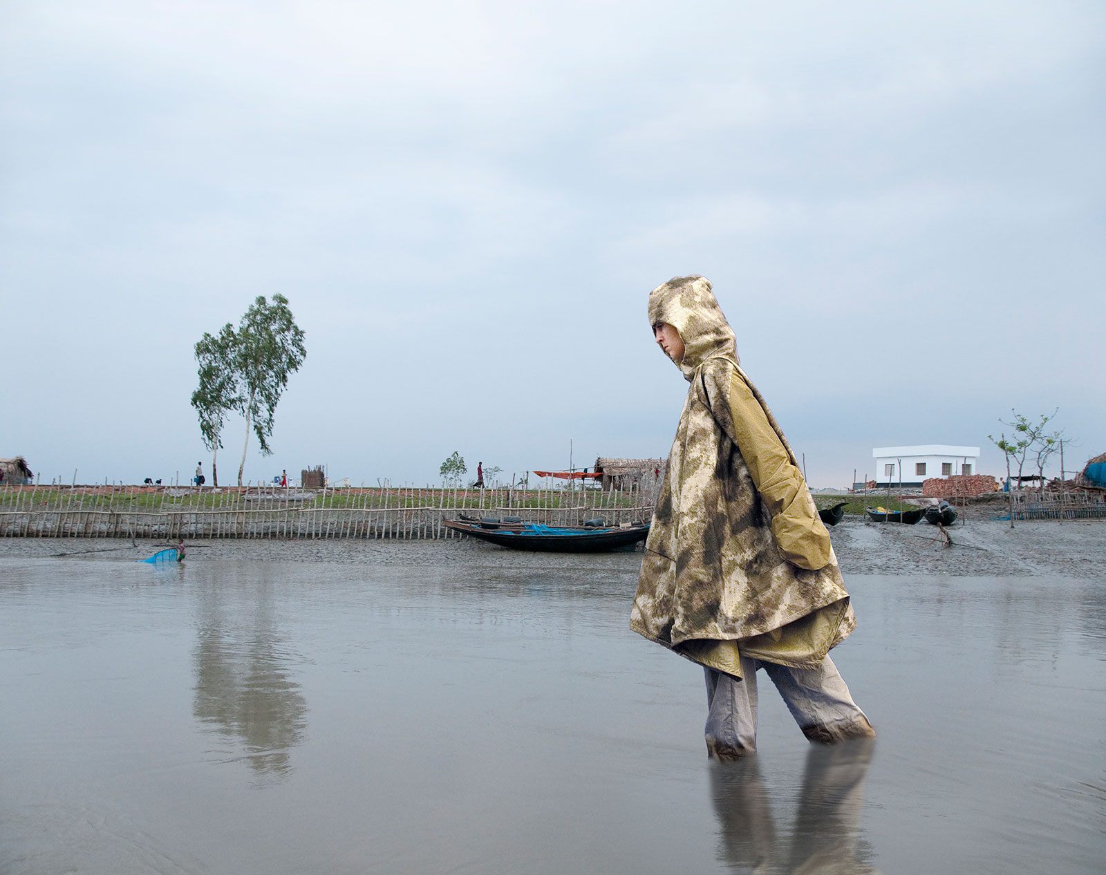 woman wading in water wearing portable shelter jacket