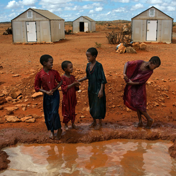 African children in front of temporary housing