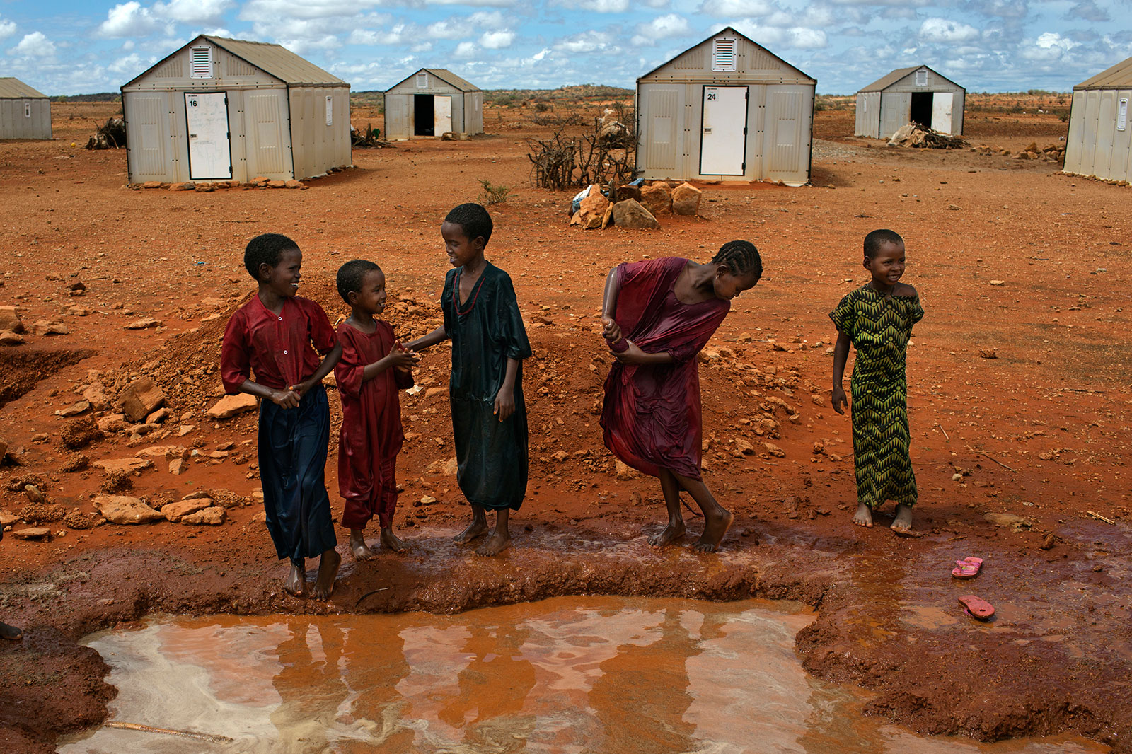 African children in front of temporary housing