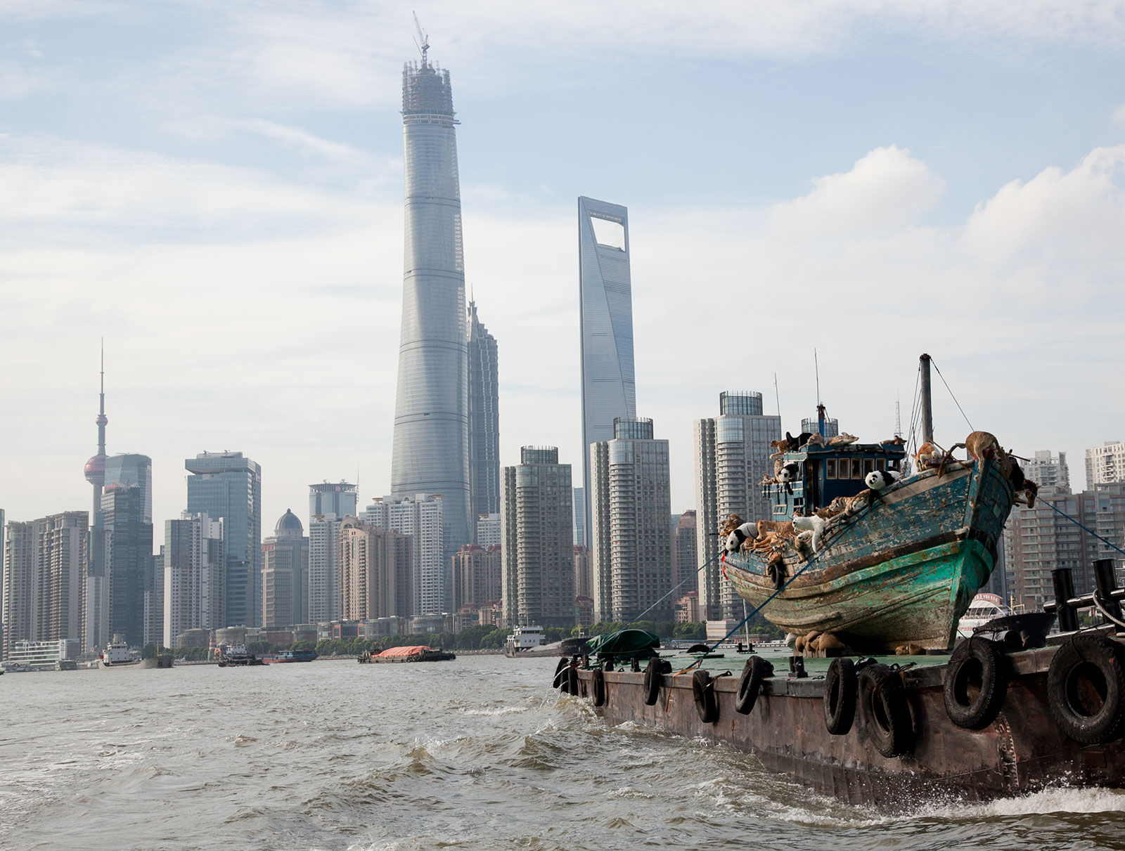 fishing boat with wildlife replicas floating toward city