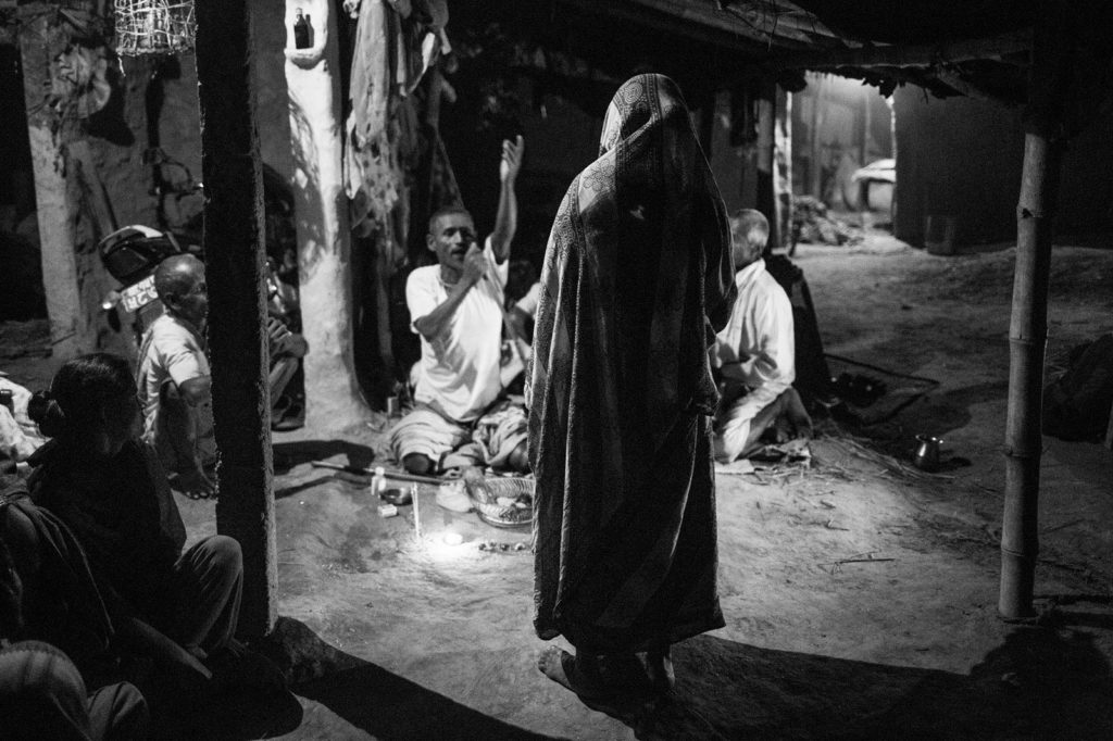 elderly woman in Nepal standing in ceremony