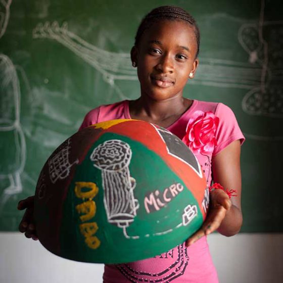 girl from Senegal holding painted bowl