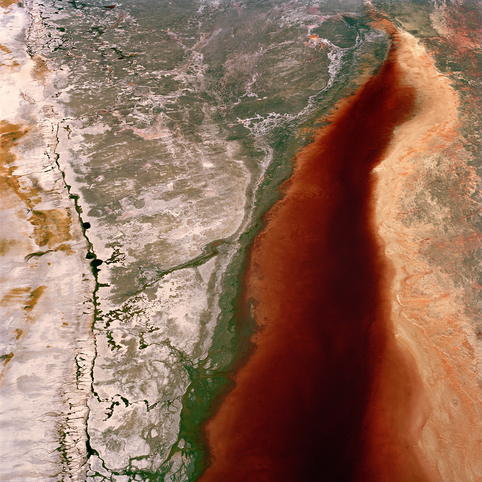 rust colored water in dry lakebed